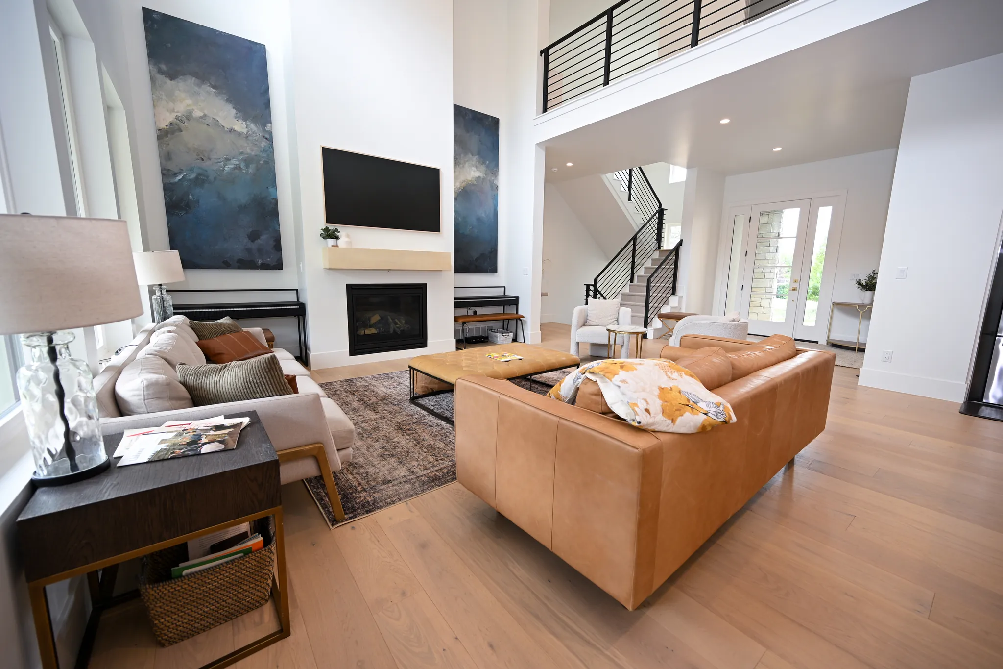 Living room with a fireplace and an open stair with black railings