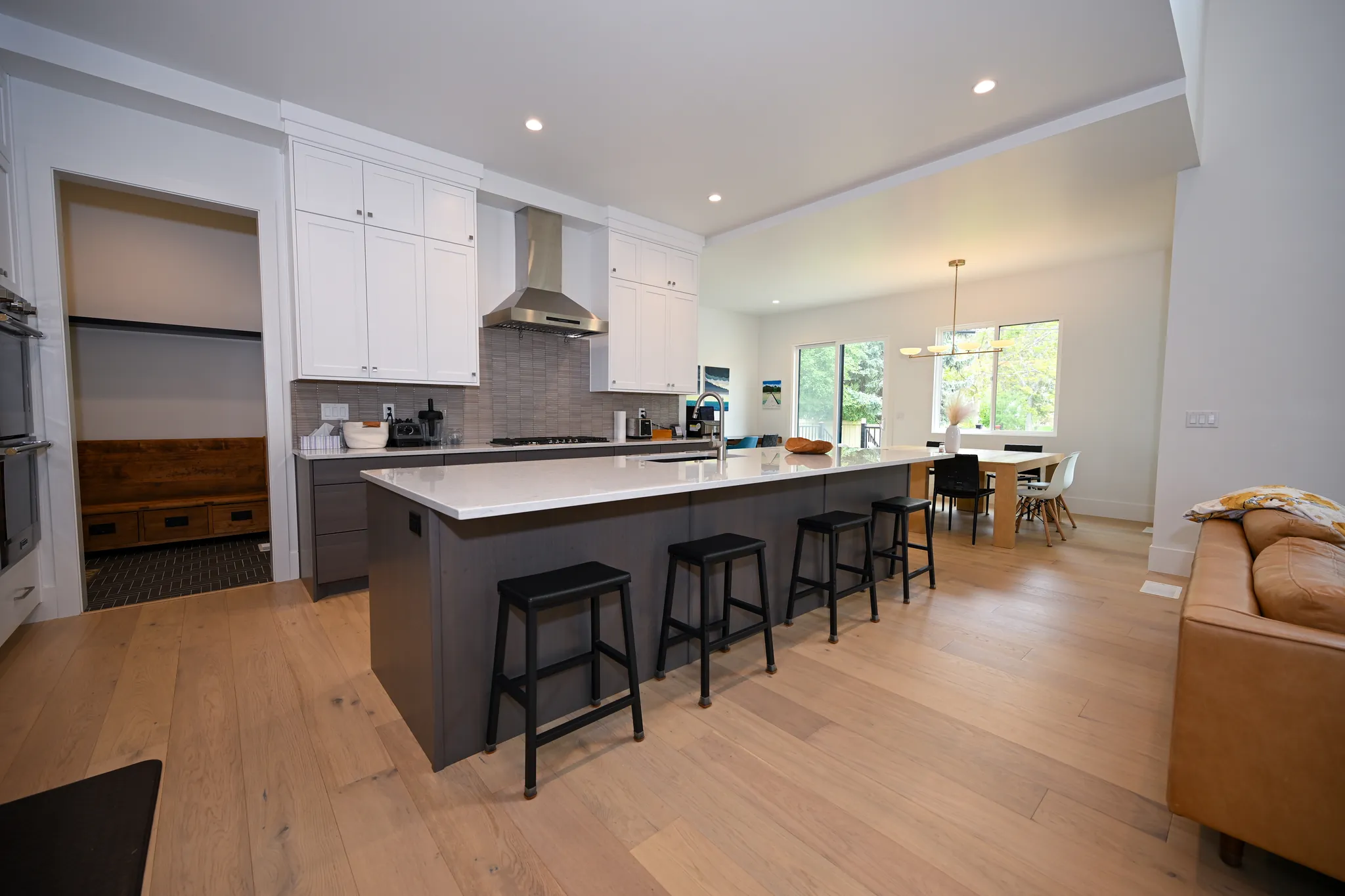 Kitchen with a dark island and white cabinetry, Boyd Residence