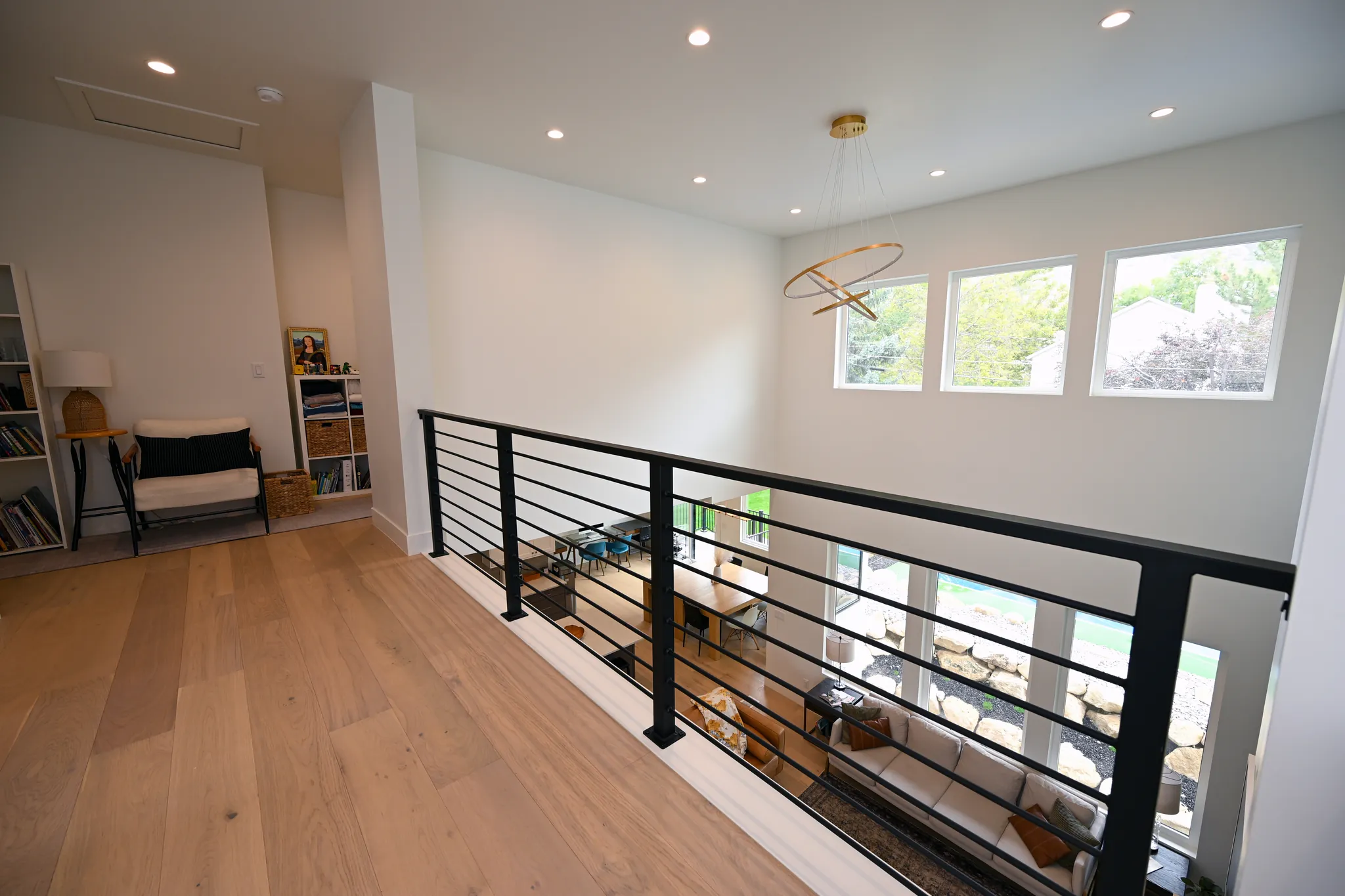 Upstairs loft with a black railing overlooking the great room