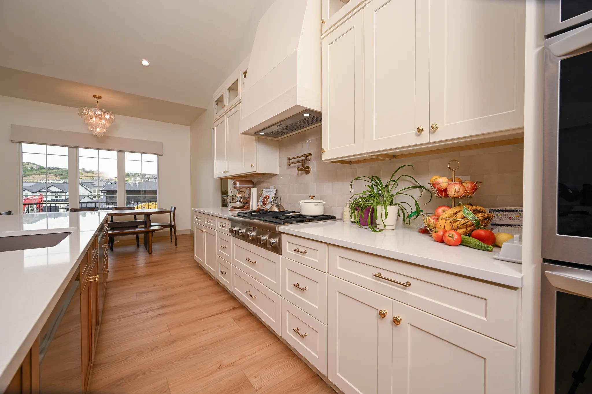 Kitchen range wall with cream cabinets and brass hardware