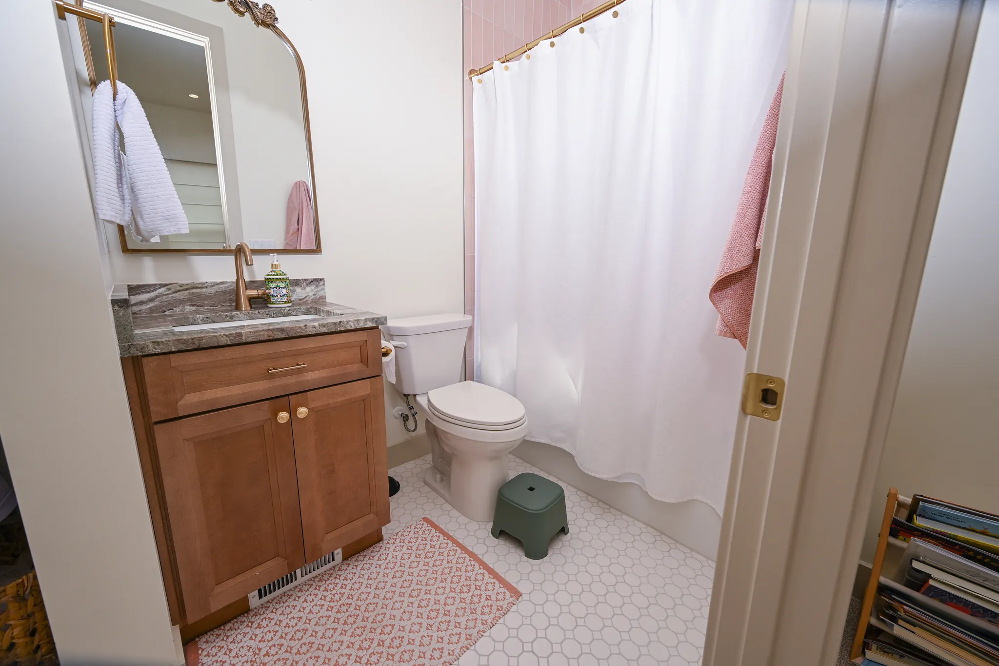 Bathroom with a wood vanity and hexagon tile floor