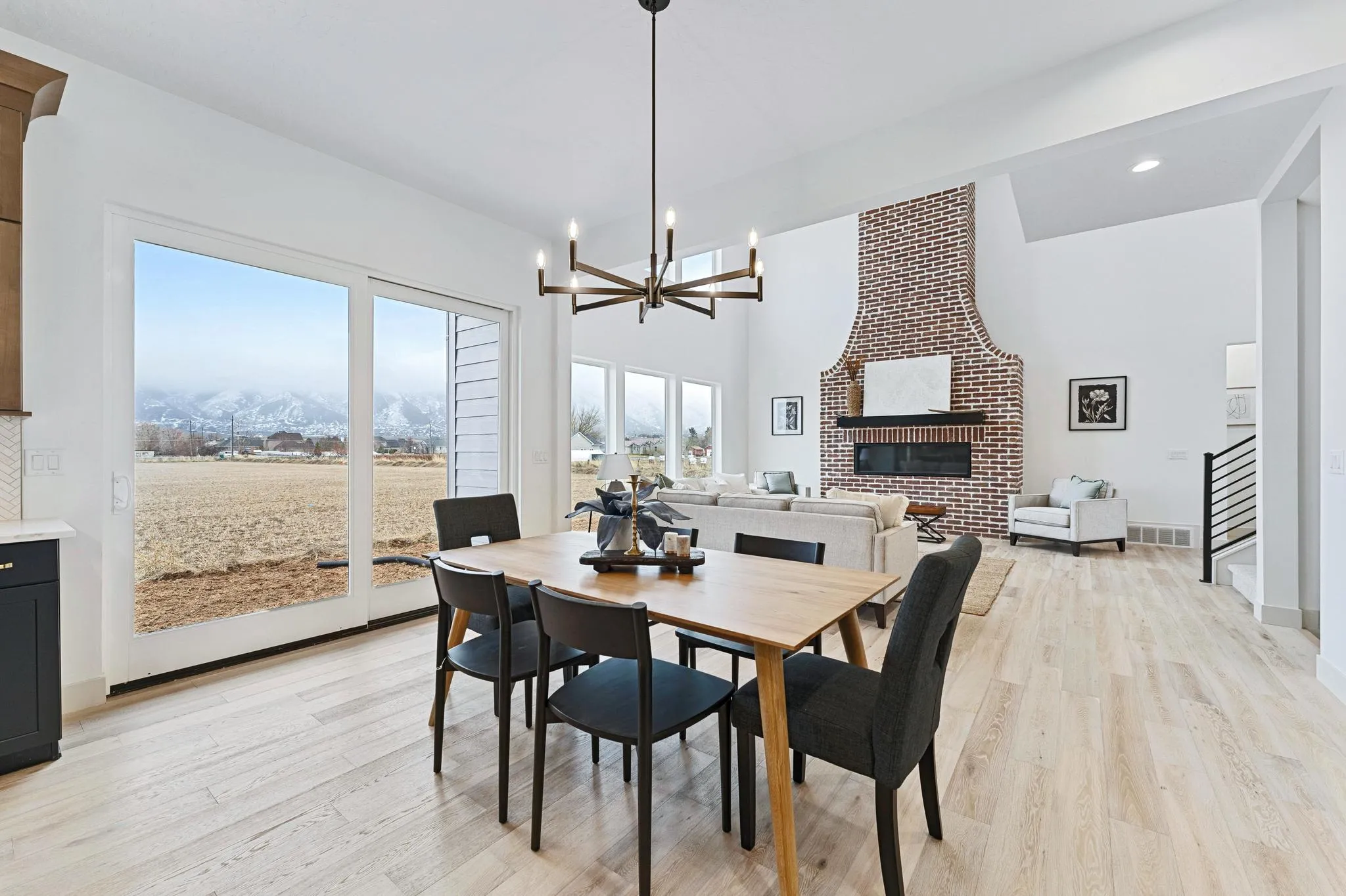 Open dining room with a brick fireplace and mountain views, Maple Grove Farmstead