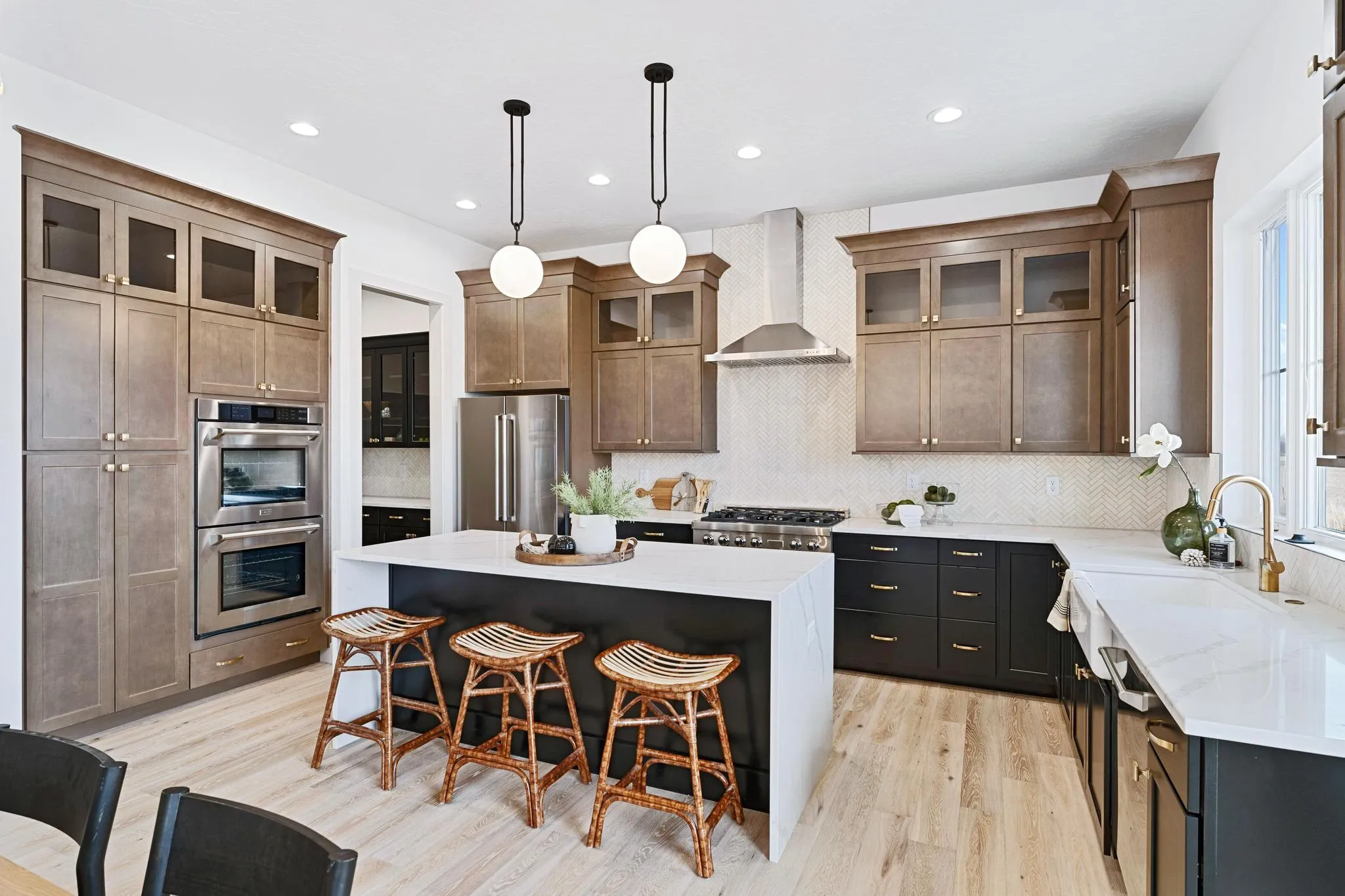 Kitchen with walnut cabinetry and a waterfall island