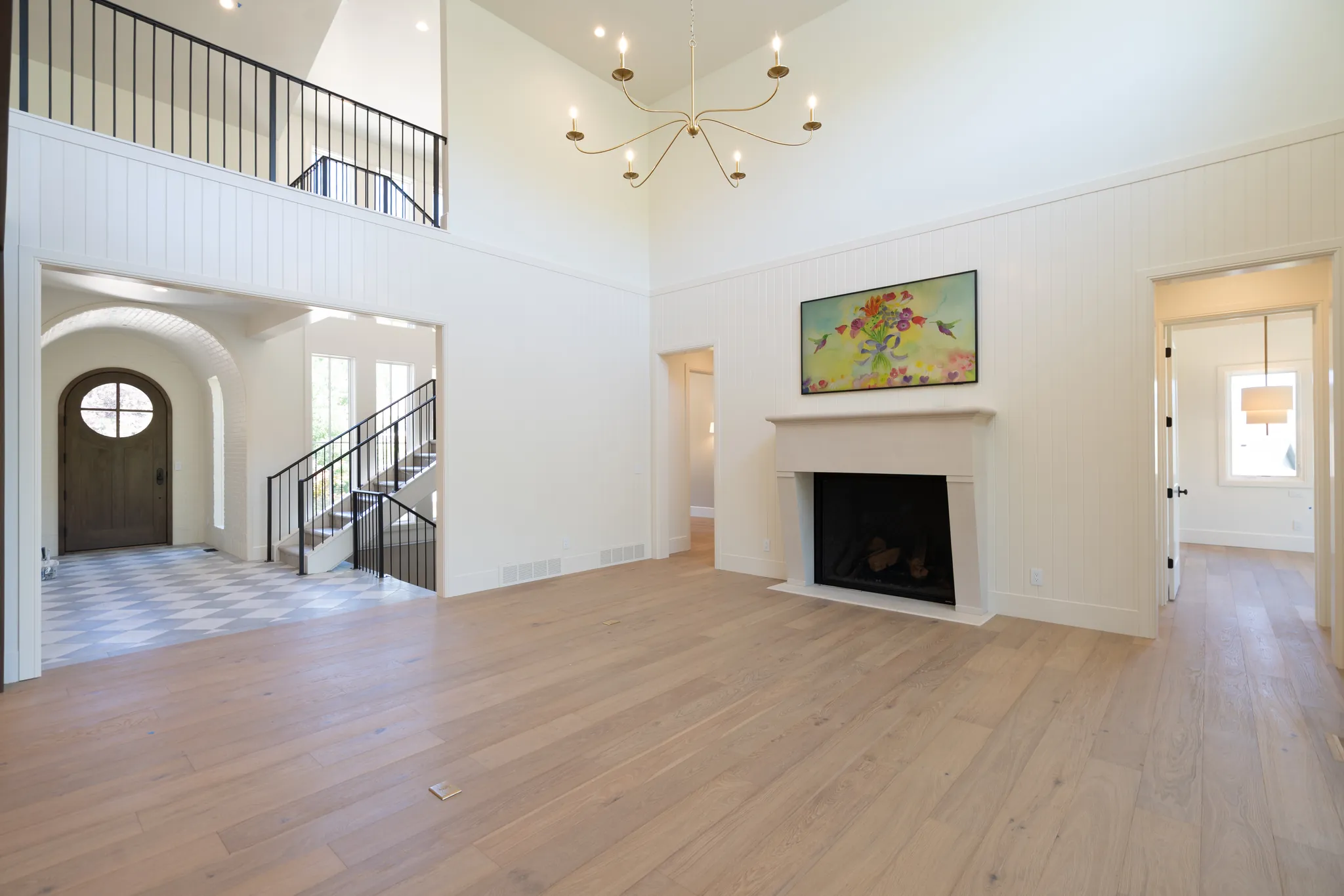 Two-story great room with a fireplace and an open loft above the entry