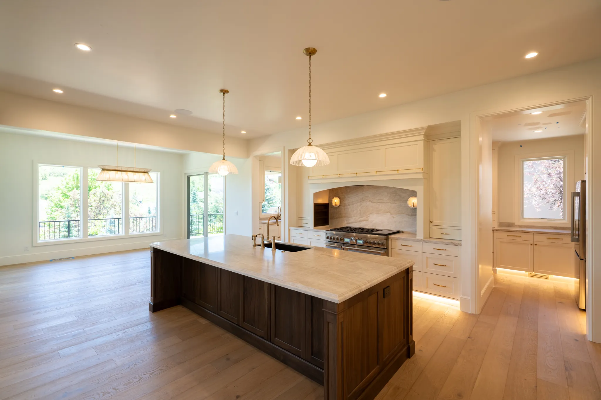 The kitchen, with a large island and a stone-backed range alcove