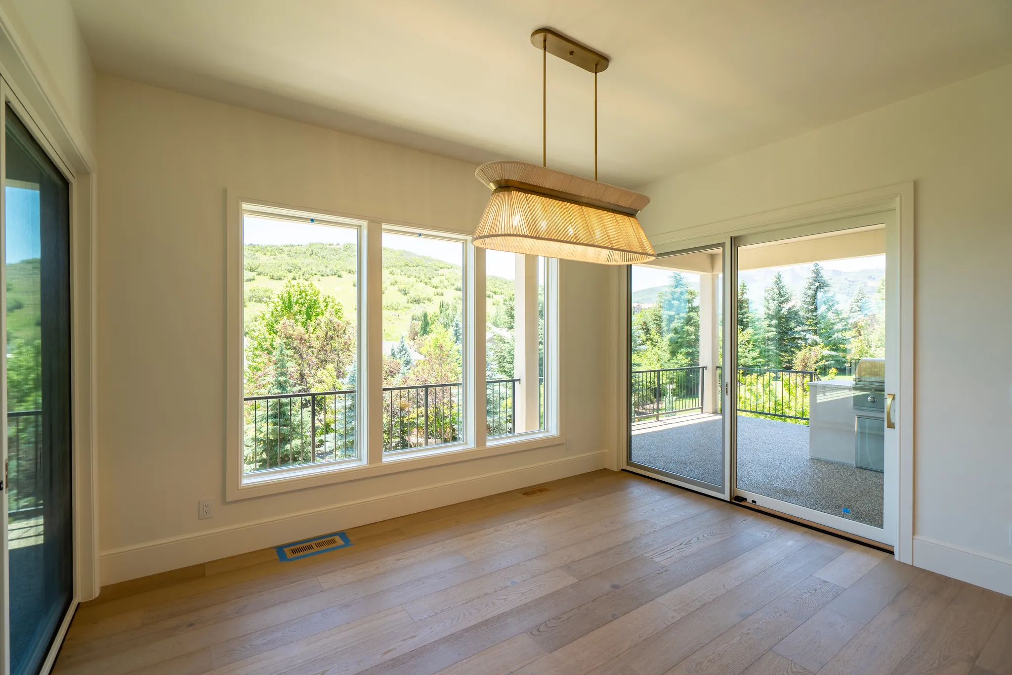 Dining nook with a sliding door to the covered deck and views of the hills