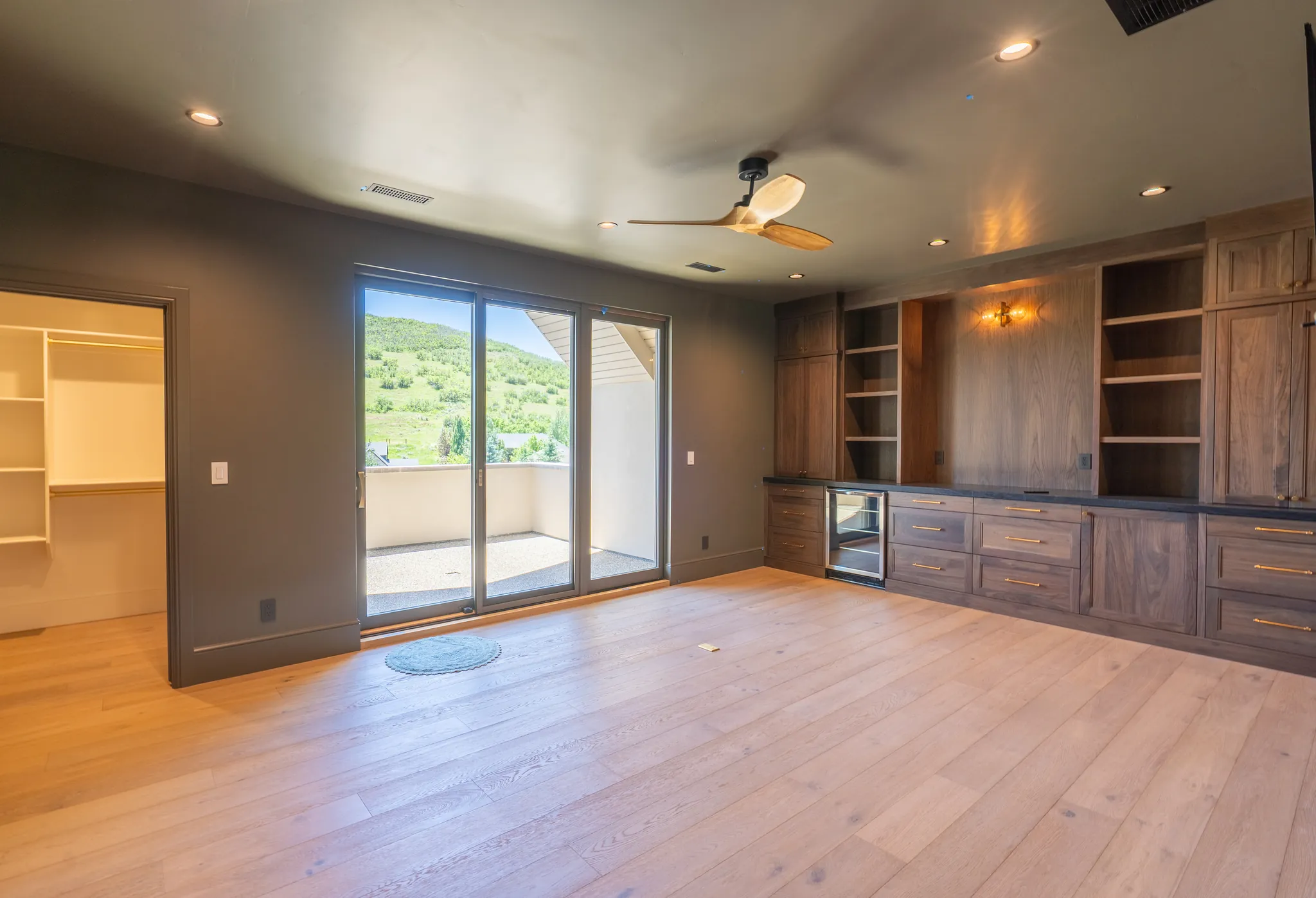 Primary bedroom with wood built-ins and sliding doors to the deck