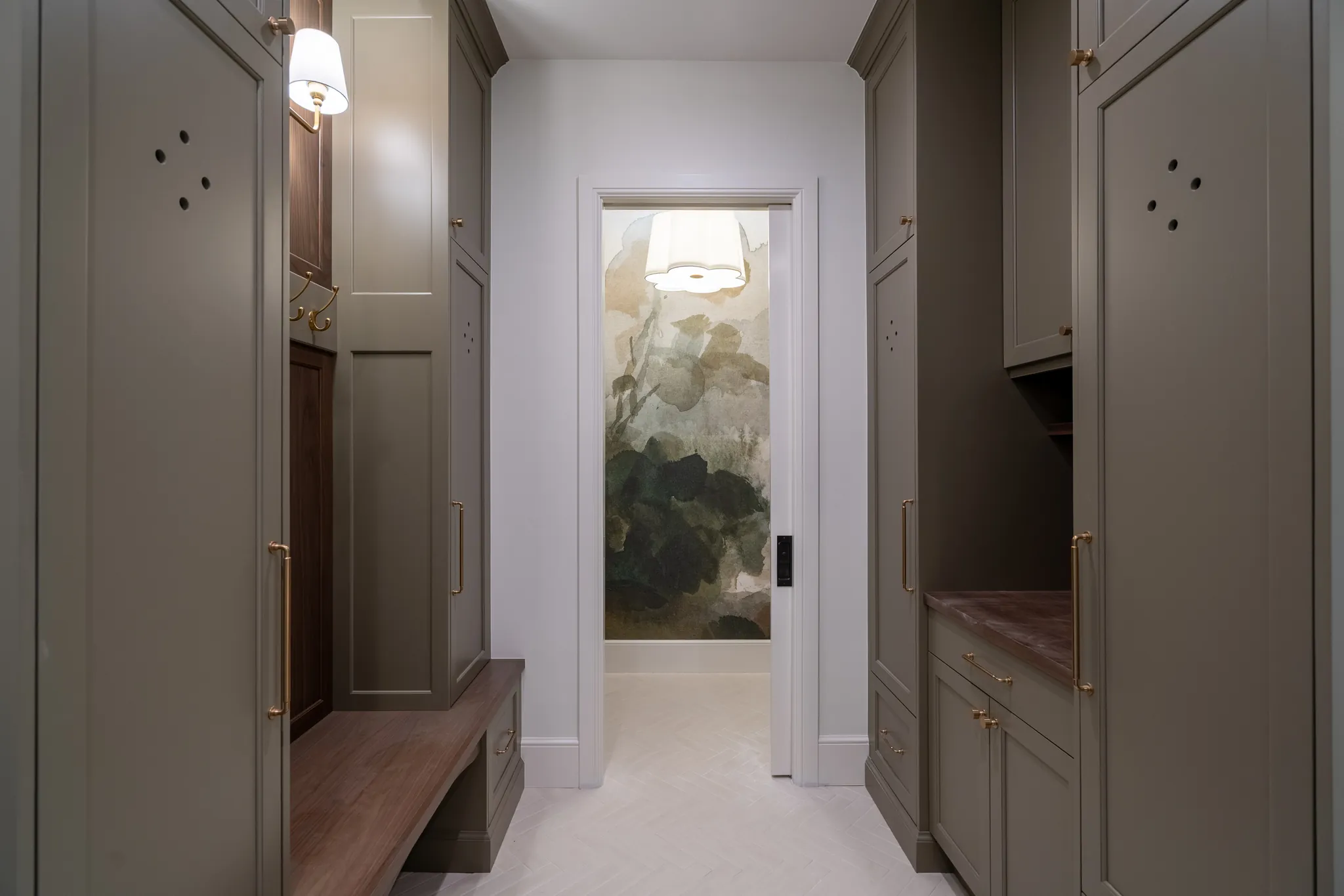 Mudroom with built-in lockers and a bench