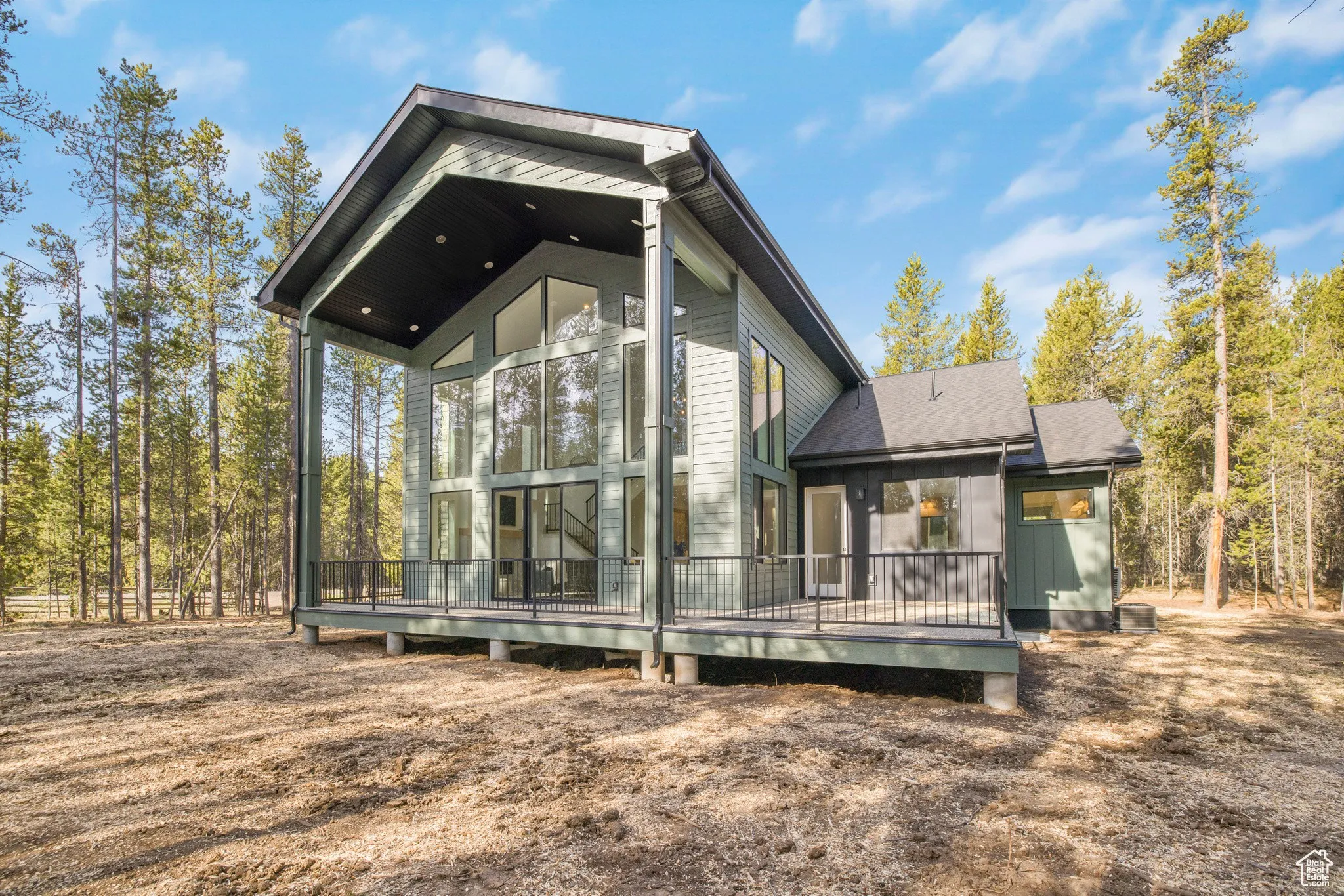 Whispering Pines, a custom mountain home with a two-story glass gable in Island Park, Idaho