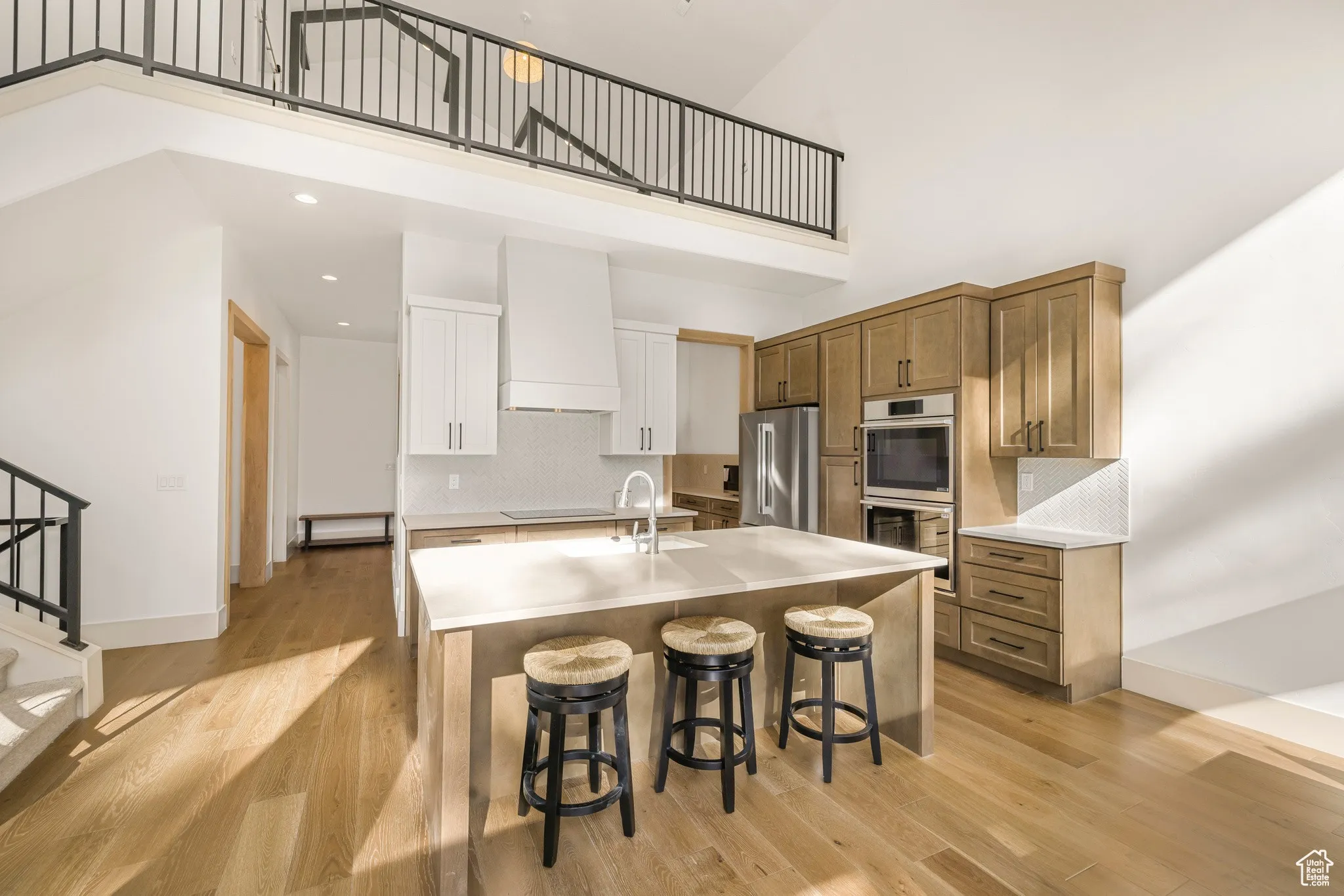The kitchen, open to vaulted living spaces and the pines beyond